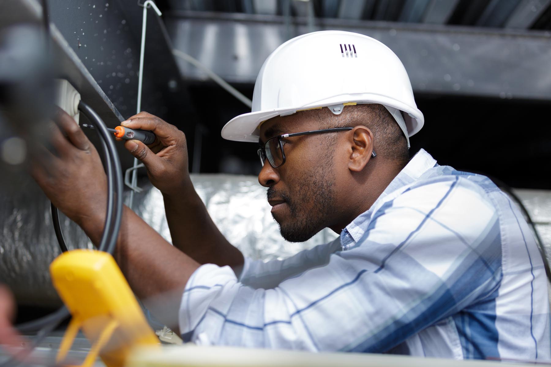 electrician fitting a cable for ceiling light